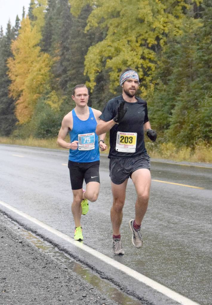 Anchorages Marshall Genn leads Soldotnas Jason Parks on Sunday, Sept. 29, 2019, at the Kenai River Marathon in Alaska. Genn won the Half Marathon, while Parks won the Marathon. (Photo by Jeff Helminiak/Peninsula Clarion)