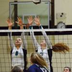 Nikiskis Kaitlyn Johnson (left) teams up with Kaycee Bostic for a block Tuesday, Oct. 1, 2019, against Soldotna at Nikiski High School in Nikiski, Alaska. (Photo by Joey Klecka/Peninsula Clarion)