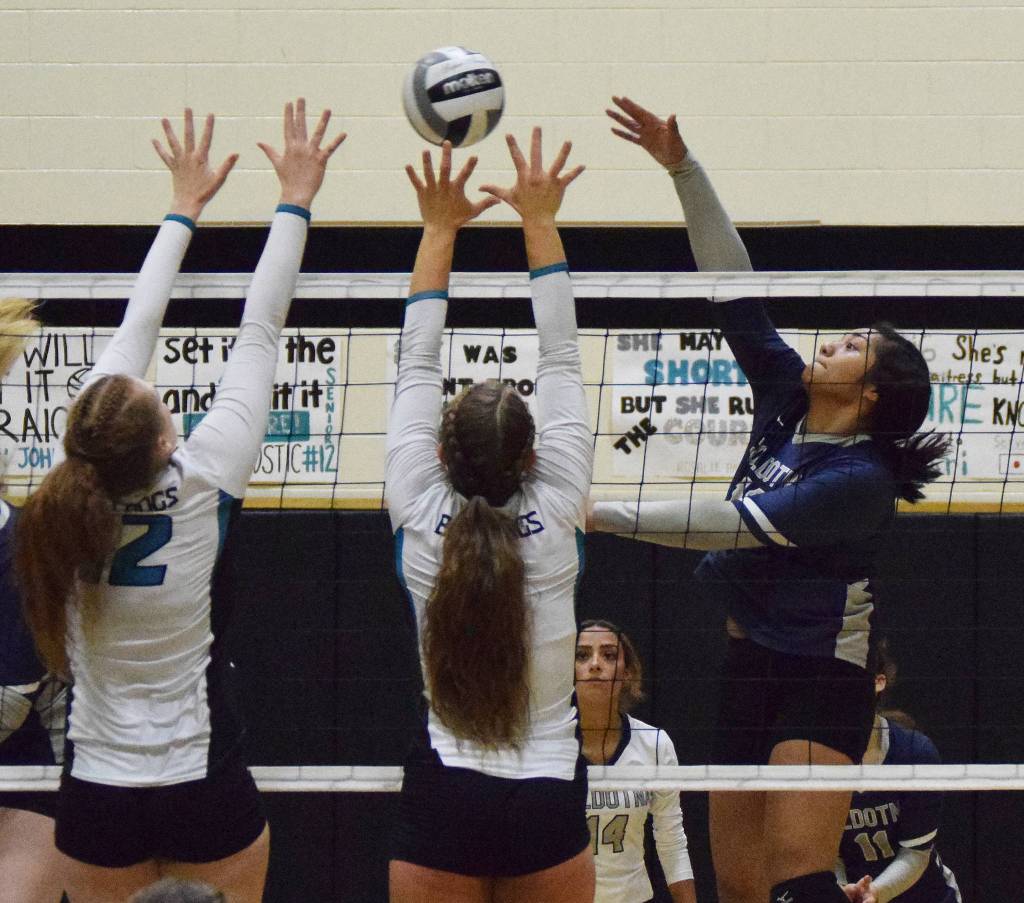 Soldotnas Ituau Tuisaula (right) sends a ball by the Nikiski tandem of Kaycee Bostic and Kaitlyn Johnson Tuesday, Oct. 1, 2019, at Nikiski High School in Nikiski, Alaska. (Photo by Joey Klecka/Peninsula Clarion)
