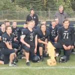The Nikiski football team shows off the Fish Bowl trophy they won by toppling Seward on Friday at Nikiski High School in Nikiski, Alaska. (Photo by Jeff Helminiak/Peninsula Clarion)