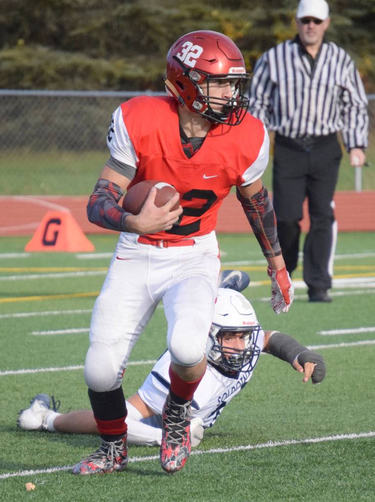 Kenai Centrals Tucker Vann eludes the tackle of Soldotnas Chris Jaime on Saturday, Oct. 5, 2019, at Ed Hollier Field at Kenai Central High School in Kenai, Alaska. (Photo by Jeff Helminiak/Peninsula Clarion)