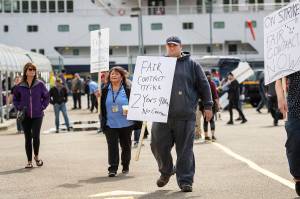 Alaska Marine Highway System workers assemble next to the AMHS ferry Columbia for an Inlandboatmens Union of the Pacific strike after failing to reach agreement on a contract with the state of Alaska, Wednesday, July 24, 2019, in Ketchikan, Alaska. (Dustin Safranek/Ketchikan Daily News via AP)