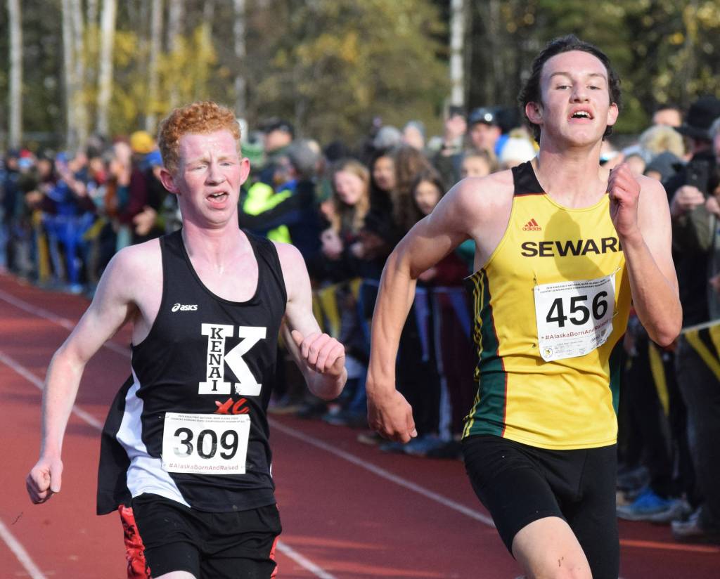Kenais Joe Hamilton (left) and Sewards Bjorn Nilsson race for 13th-place in the Div. II boys state cross-country championships Saturday, Oct. 5, 2019, on the Bartlett High trails in Anchorage, Alaska. (Photo by Joey Klecka/Peninsula Clarion)