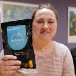 Jessica Spurrier, the Juneau Opioid Work Group Facilitator for JAMHI Health & Wellness, Inc., holds up a drug deactivation bag on Tuesday, Oct. 1, 2019. The bags make unused prescriptions safe to dispose of. (Michael Penn | Juneau Empire)