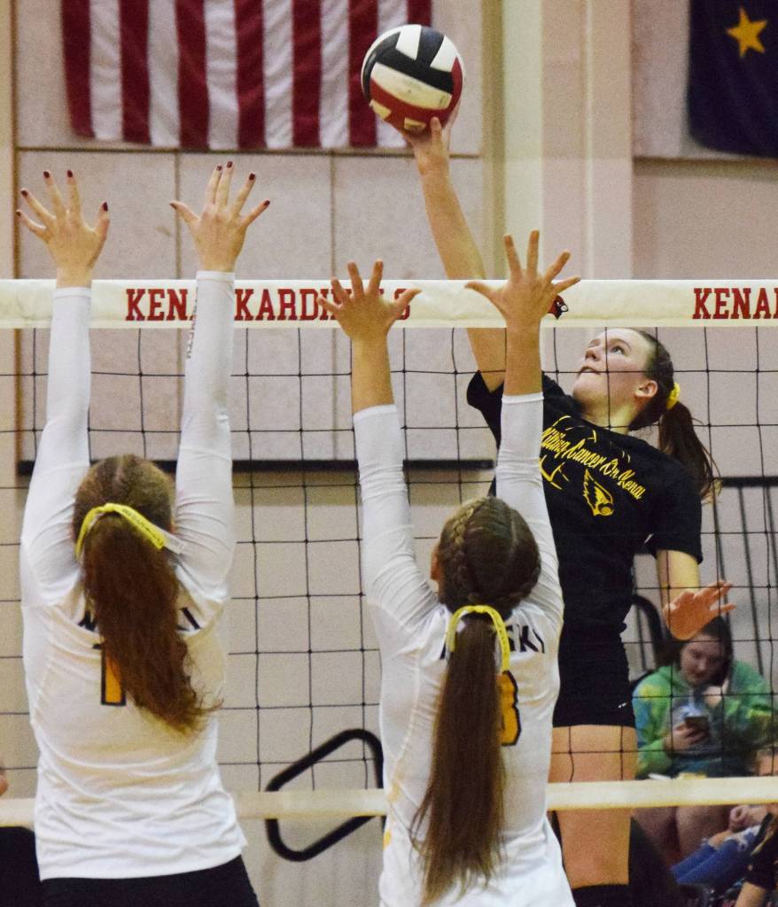 Kenais Bethany Morris hits a ball through the Nikiski duo of Kaycee Bostic (left) and Kaitlyn Johnson, Tuesday, Oct. 8, 2019, at Kenai Central High School in Kenai, Alaska. (Photo by Joey Klecka/Peninsula Clarion)