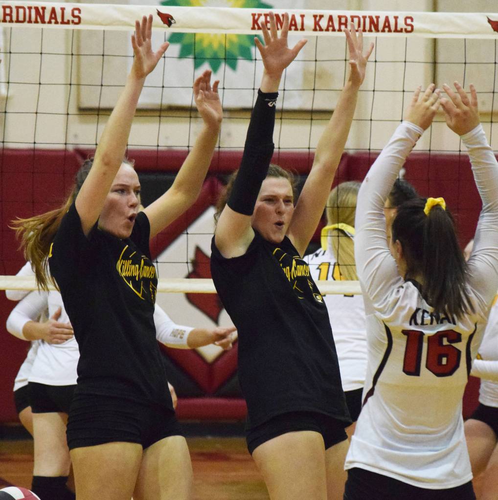 Kenai teammates Bethany Morris (left) and Abby Every celebrate a point won Tuesday, Oct. 8, 2019, against Nikiski at Kenai Central High School in Kenai, Alaska. (Photo by Joey Klecka/Peninsula Clarion)