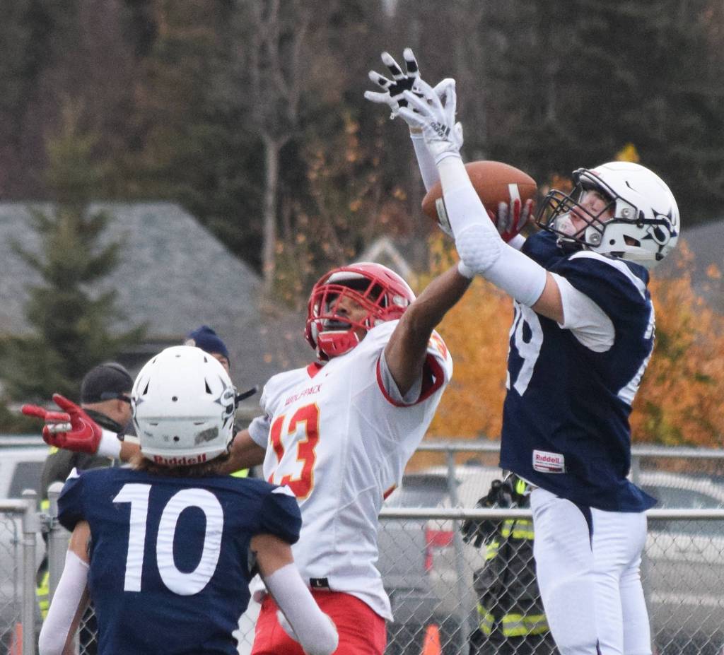 West Valleys Tyriq Nance makes a one-handed touchdown grab in front of Soldotnas Tyler Morrison (right) in a Div. II state semifinal Friday, Oct. 11, 2019, in Soldotna, Alaska. (Photo by Joey Klecka/Peninsula Clarion)