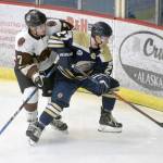 Kenai River Brown Bears forward Logan Ritchie and Janesville (Wisconsin) Jets defenseman Max Klanow battle in the corner Sunday, Oct. 14, 2019, at the Soldotna Regional Sports Complex. (Photo by Jeff Helminiak/Peninsula Clarion)