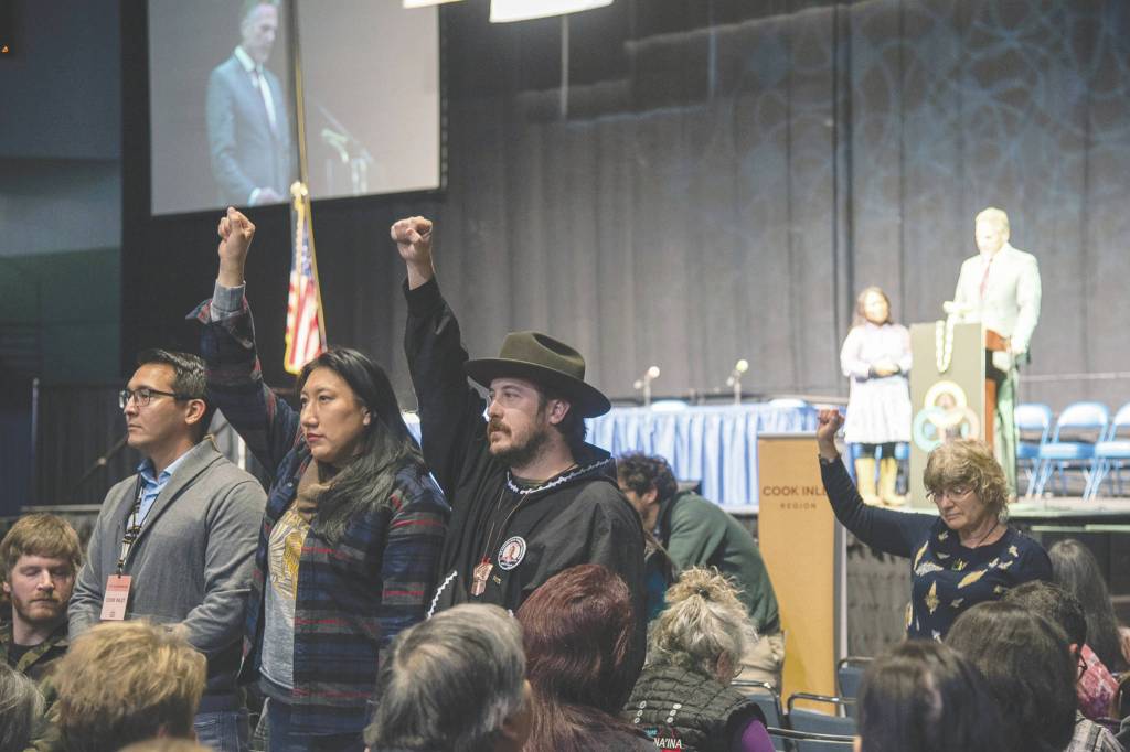 Defend the Sacred Alaska                                Protesters raise their fists during Gov. Mike Dunleavys speech at the Alaska Federation of Natives Convention on Thursday.