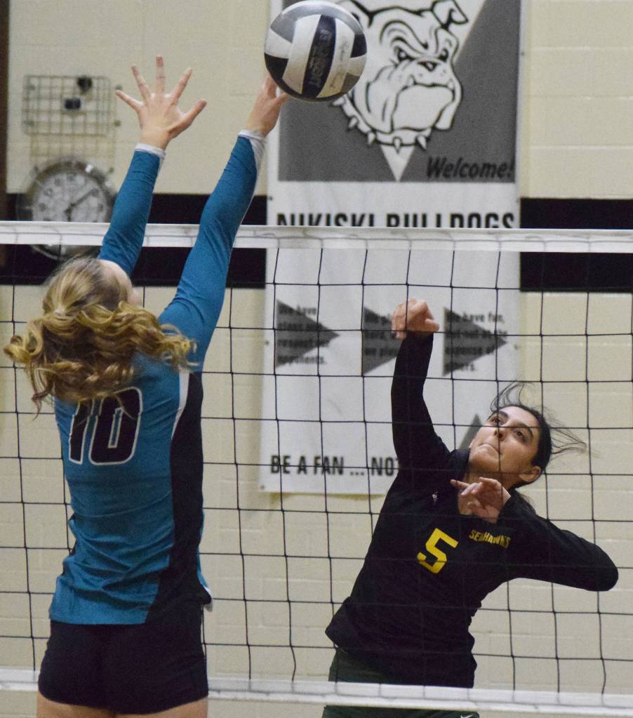 Sewards Sofia Perazzi sends a hit over Nikiskis Lillian Carstens, Thursday, Oct. 17, 2019, at Nikiski High School in Nikiski, Alaska. (Photo by Joey Klecka/Peninsula Clarion)1