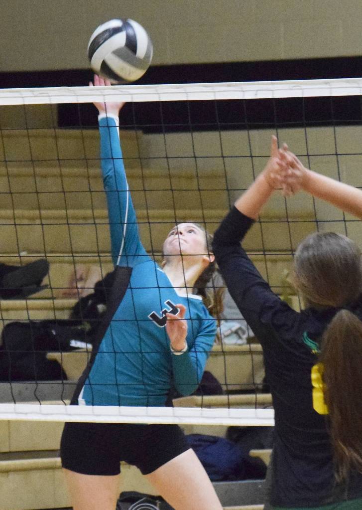 Nikiskis Jaycee Tauriainen delivers a hit on the Seward defense Thursday, Oct. 17, 2019, at Nikiski High School in Nikiski, Alaska. (Photo by Joey Klecka/Peninsula Clarion)