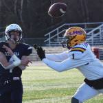 Soldotna quarterback Jersey Truesdell throws a pass with pressure from Lathrops Jace Henry, Saturday, Oct. 19, 2019, at the Div. II state football championship at Anchorage Football Stadium in Anchorage, Alaska. (Photo by Joey Klecka/Peninsula Clarion)