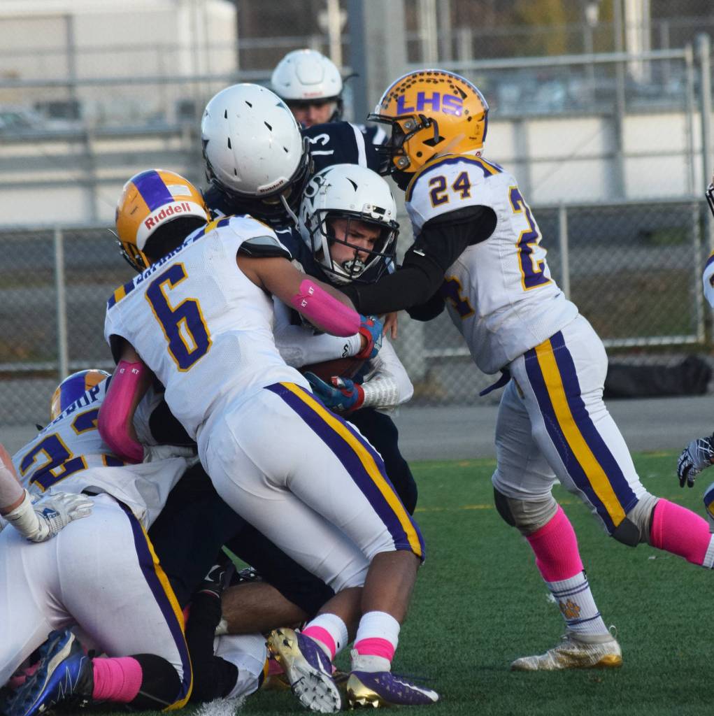 Soldotnas Wyatt Medcoff pushes his way through a scrum of Lathrop defenders Saturday, Oct. 19, 2019, at the Div. II state football championship at Anchorage Football Stadium in Anchorage, Alaska. (Photo by Joey Klecka/Peninsula Clarion)