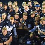 Members of the Soldotna football team pose with the trophy Saturday, Oct. 19, 2019, at the Div. II state football championship at Anchorage Football Stadium in Anchorage, Alaska. Soldotna defeated Lathrop 69-13. (Photo by Joey Klecka/Peninsula Clarion)