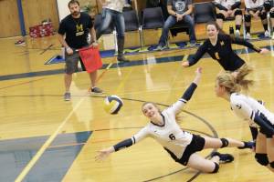 Homers Karmyn Gallios dives for the ball during a Tuesday, Oct. 29, 2019 volleyball game against Kenai Central High School in the Alice Witte Gymnasium in Homer, Alaska. (Photo by Megan Pacer/Homer News)