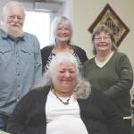 Grand Group members Joe Carlson, left, Nancy Carlson, front center, Sue Gill, back center and Vicki Fruichantie, right smile for the camera at the Childrens Advocacy Center in Kenai, Alaska on Oct. 3, 2019. (Photo by Brian Mazurek/Peninsula Clarion)
