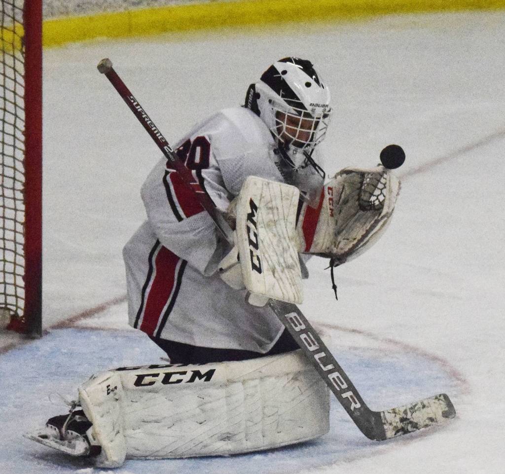 Kenai goaltender Jackson Cross makes a save on a Dimond shot Friday, Nov. 1, 2019, at the Peninsula Ice Challenge tournament at the Kenai Multi-Purpose Facility in Kenai, Alaska. (Photo by Joey Klecka/Peninsula Clarion)