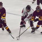 Kenais Tucker Vann battles for the puck with Dimonds Dakota Toombs (left) and Colton Reid, Friday, Nov. 1, 2019, at the Peninsula Ice Challenge tournament at the Kenai Multi-Purpose Facility in Kenai, Alaska. (Photo by Joey Klecka/Peninsula Clarion)