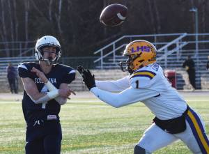Soldotna quarterback Jersey Truesdell throws a pass with pressure from Lathrops Jace Henry, Saturday, Oct. 19, 2019, at the Div. II state football championship at Anchorage Football Stadium in Anchorage, Alaska. (Photo by Joey Klecka/Peninsula Clarion)