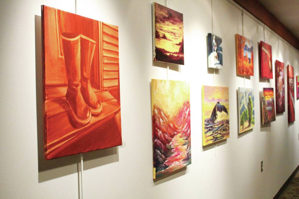 Artwork by students in an art class taught by Asia Freeman hangs on the wall during a First Friday exhibit opening Friday, Nov. 1, 2019 at Kachemak Bay Campus in Homer, Alaska. (Photo by Megan Pacer/Homer News)