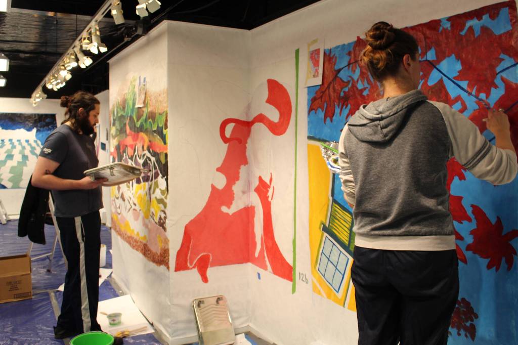 Artists Jason Ramirez, left, and Tasha Skolnick, right, work on their portion of the mural at the Kenai Fine Art Center in Kenai, Alaska, on Saturday, Nov. 2, 2019. (Photo by Brian Mazurek/Peninsula Clarion)