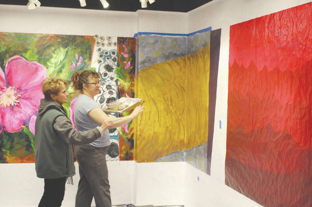 Brian Mazurek / Peninsula Clarion                                 Peninsula Art Guild Vice President Marion Nelson (left) and artist Rachel Grossl examine a portion of the Gather mural at the Kenai Fine Art Center on Saturday.
