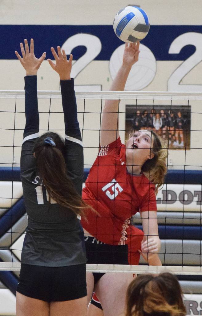Wasillas Bella Hays sends a ball over the hands of Soldotnas Trayce Lyon, Thursday, Nov. 7, 2019, at the Northern Lights Conference tournament at Soldotna High School in Soldotna, Alaska. (Photo by Joey Klecka/Peninsula Clarion)