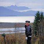 Eric Henley of the Veterans of Foreign Wars, Anchor Point Post, salutes a helmet and rifle  symbolizing those lost in U.S. wars  on Nov. 11, 2019, for Veterans Day ceremonies at the Alaska Islands and Ocean Visitor Center in Homer, Alaska. (Photo by Michael Armstrong / Homer News)