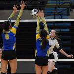 Homers Laura Inama tips a ball over Kotzebues Laveah Makisi (left) and Kaila Short, Thursday, Nov. 14, 2019, at the Class 4A state volleyball tournament at the Alaska Airlines Center in Anchorage, Alaska. (Photo by Joey Klecka/Peninsula Clarion)