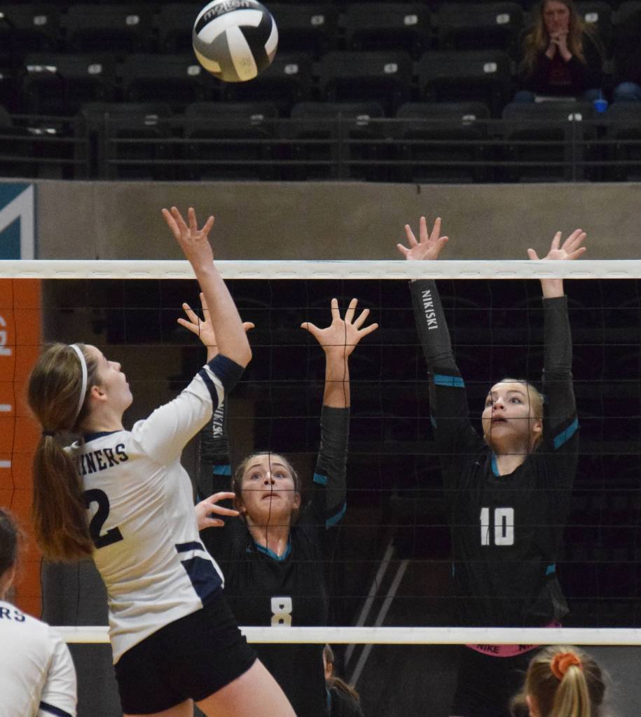 Nikiskis Kaitlyn Johnson (left) and Lillian Carstens team up for a block against Homers Laura Inama, Thursday, Nov. 14, 2019, at the Class 3A state volleyball tournament at the Alaska Airlines Center in Anchorage, Alaska. (Photo by Joey Klecka/Peninsula Clarion)