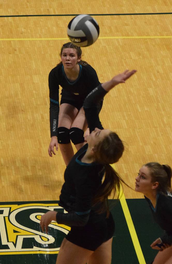 Nikiskis Jaycee Tauriainen watches as teammate Lillian Carstens hits a ball Thursday, Nov. 14, 2019, against Monroe Catholic at the Class 3A state volleyball tournament at the Alaska Airlines Center in Anchorage, Alaska. (Photo by Joey Klecka/Peninsula Clarion)
