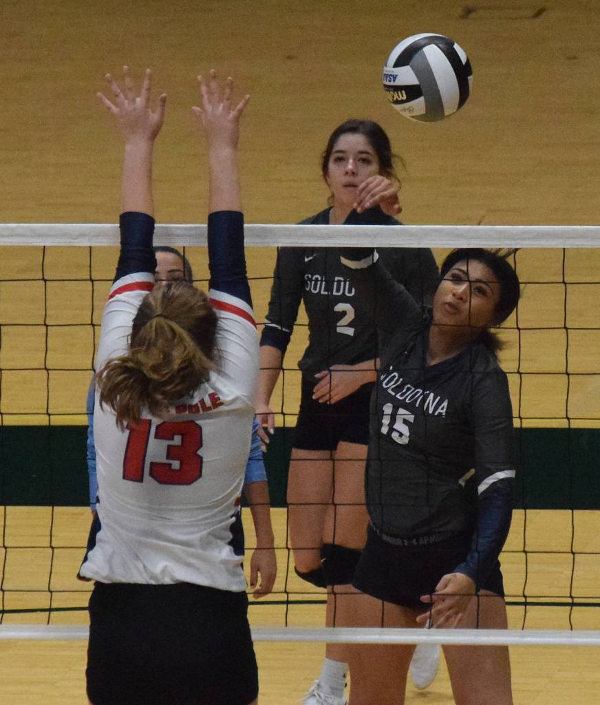 Soldotnas Serena Foglia blasts a shot over North Pole blocker Madyson Conley, Friday, Nov. 15, 2019, at the Class 4A state volleyball tournament at the Alaska Airlines Center in Anchorage, Alaska. (Photo by Joey Klecka/Peninsula Clarion)