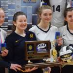 Members of the Homer volleyball team hold up the Class 3A state championship trophy Saturday, Nov. 16, 2019, at the Class 3A state volleyball tournament at the Alaska Airlines Center in Anchorage, Alaska. (Photo by Joey Klecka/Peninsula Clarion)