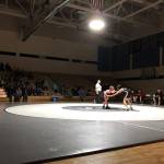 A lone spotlight highlights the action Tuesday, Nov. 19, 2019, at a Kenai/Nikiski dual meet at Nikiski High School. (Photo by Joey Klecka/Peninsula Clarion)