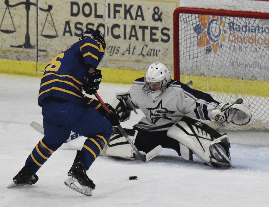 Homers Ethan Pitzman challenges Soldotna goalie Corbin Wirz at the net Friday, Nov. 22, 2019, at the Soldotna Regional Sports Complex in Soldotna, Alaska. (Photo by Joey Klecka/Peninsula Clarion)
