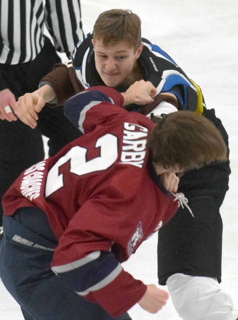 Kenai River Brown Bears forward Porter Schachle trades blows with Fairbanks Ice Dogs defenseman Andrew Garby on Friday, Nov. 22, 2019, at the Soldotna Regional Sports Complex in Soldotna, Alaska. (Photo by Jeff Helminiak/Peninsula Clarion)