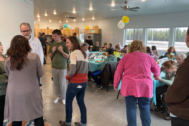 Residents of the Kenai Intentional Neighborhood celebrate the completion of their clubhouse with friends, family and Hope Community Resources board members in Soldotna, Alaska on Nov. 22, 2019. (Photo courtesy Kathy Fitzgerald)