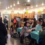 Residents of the Kenai Intentional Neighborhood celebrate the completion of their clubhouse with friends, family and Hope Community Resources board members in Soldotna, Alaska on Nov. 22, 2019. (Photo courtesy Kathy Fitzgerald)