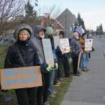 People hold signs Saturday, Nov. 23, 2019, at a vigil for Anesha Duffy Murnane, a Homer woman missing since Oct. 17, at WKFL Park in Homer, Alaska. (Photo by Michael Armstrong/Homer News)