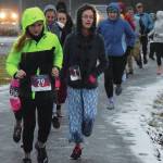 Two runners race together early Thursday, Nov. 28, 2019, at the Turkey Trot in Soldotna, Alaska. (Photo by Joey Klecka/Peninsula Clarion)