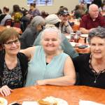 From left, Diane Somers, Cindy Todd and Barbara Cooper smile for the camera during the Thanksgiving community potluck at College Heights Baptist Church in Soldotna, Alaska, on Thursday, Nov. 28, 2019. (Photo by Brian Mazurek/Peninsula Clarion)