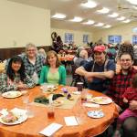 From left, Priscilla Tapangco, Carol Kvasnikoff, Annaleah Karron, Mike Karron, Charlie Karron and Allison Karron smile for the camera during the Thanksgiving community potluck at College Heights Baptist Church in Soldotna, Alaska, on Thursday, Nov. 28, 2019. (Photo by Brian Mazurek/Peninsula Clarion)
