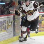Kenai River Brown Bears forward Max Helgeson chases the puck along the boards against the Fairbanks Ice Dogs on Friday, Nov. 22, 2019, at the Soldotna Regional Sports Complex in Soldotna, Alaska. (Photo by Jeff Helminiak/Peninsula Clarion)