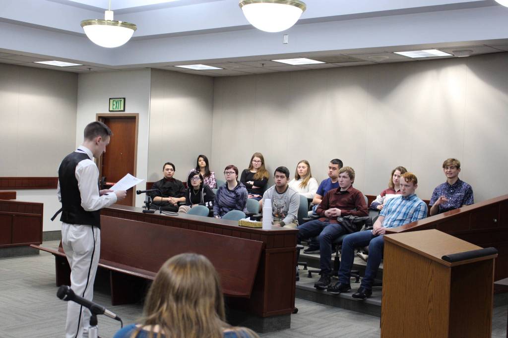 Nikiski Middle/High School senior Bryan McCollum, in his role as defense attorney, gives a closing statement to the jury during a mock trial at the Kenai Courthouse on Dec. 3, 2019. (Photo by Brian Mazurek/Peninsula Clarion)