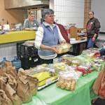 Volunteers staff the kitchen and buffet line at the Jan. 24, 2018, Project Homeless Connect at the Soldotna Regional Sports Complex. The annual event gathers service providers, nonprofits and volunteers to support members of the homeless community and those in need. (Photo by Erin Thompson/Peninsula Clarion)