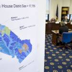 In this file photo, a House district map shows district population numbers as the Alaska Redistricting Board hears testimony at the Capitol on Friday, March 25, 2011. (Juneau Empire File)