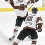 Kenai River Brown Bears defenseman Bryan Huggins celebrates his game-winning goal against the Janesville (Wisconsin) Jets with Tristan Culleton on Friday at the Soldotna Regional Sports Complex in Soldotna. (Photo by Jeff Helminiak/Peninsula Clarion)