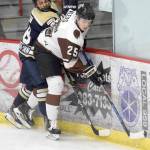 Kenai River Brown Bears defenseman Preston Weeks, of Soldotna, shields the puck from Janesville (Wisconsin) Jets defenseman Charlie Schoen on Friday at the Soldotna Regional Sports Complex in Soldotna. (Photo by Jeff Helminiak/Peninsula Clarion)