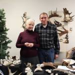 Phoebe and Rick Abbott, owners of Alaskan Birdhouses and Crafts, display some of their carvings for sale at the annual Central Peninsula Hospital Auxiliary Holiday Bazaar in Soldotna, Alaska on Dec. 6, 2019. (Photo by Brian Mazurek/Peninsula Clarion)