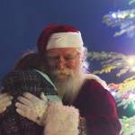 Santa Claus gives a young girl a hug Saturday, Dec. 7, 2019, at the Christmas in the Park celebration at Soldotna Creek Park in Soldotna, Alaska. (Photo by Joey Klecka/Peninsula Clarion)